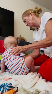 A baby working on early movement skills during an in-home physical therapy session.